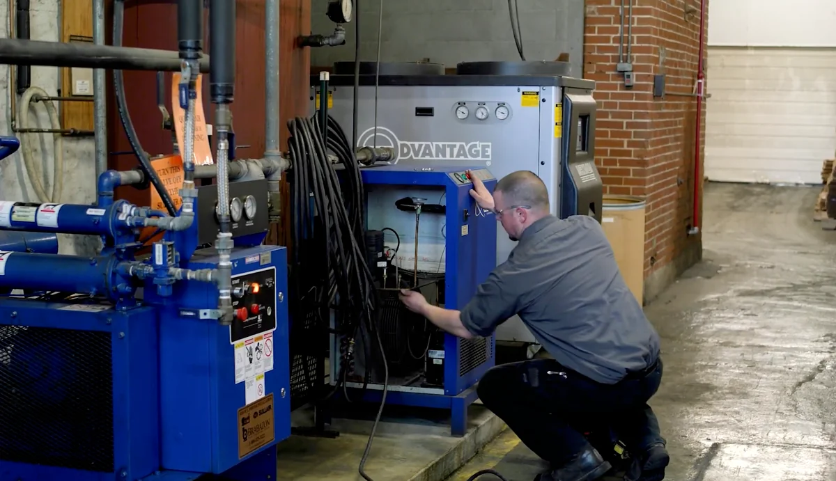 Brabazon technician servicing a refrigerated compressed air dryer at a customer facility