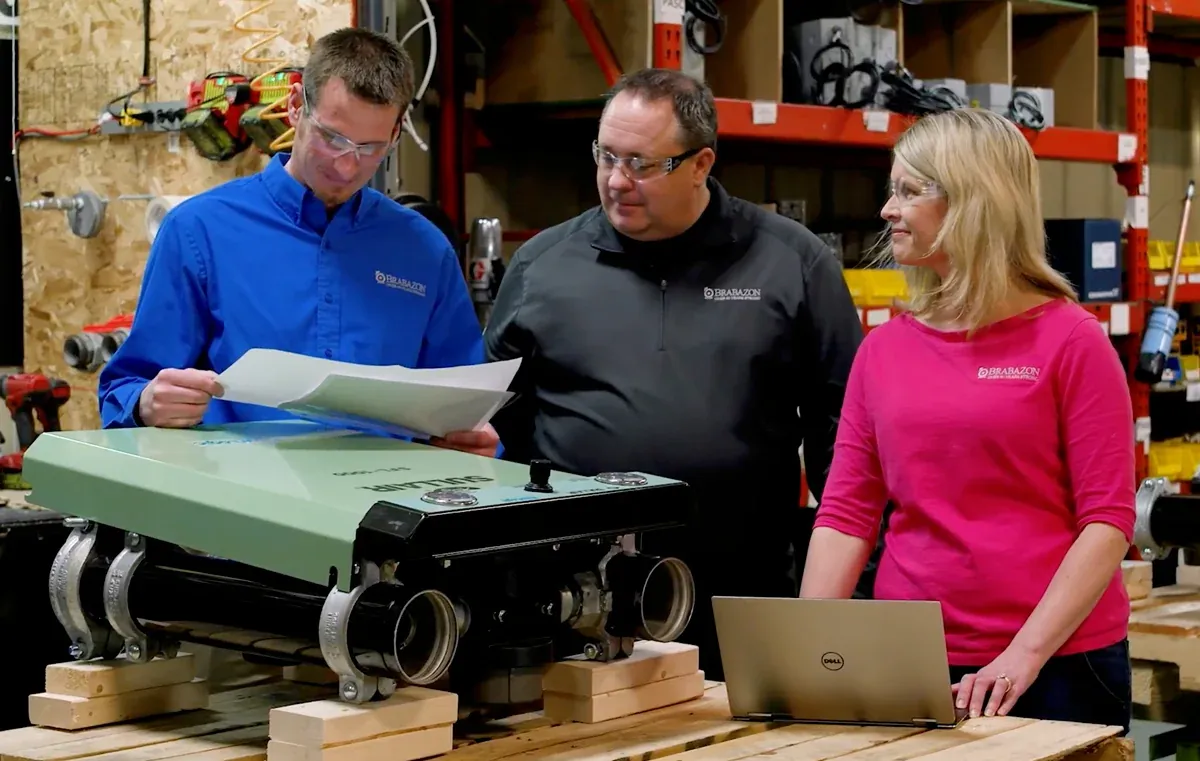 Brabazon sales and service team reviewing specifications beside a new Sullair unit