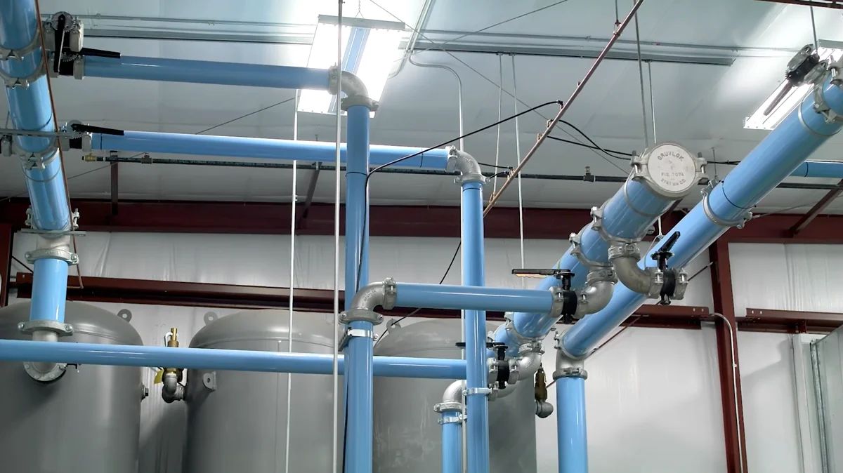 Completed compressed air piping installation with aluminum lines and air receiver tanks