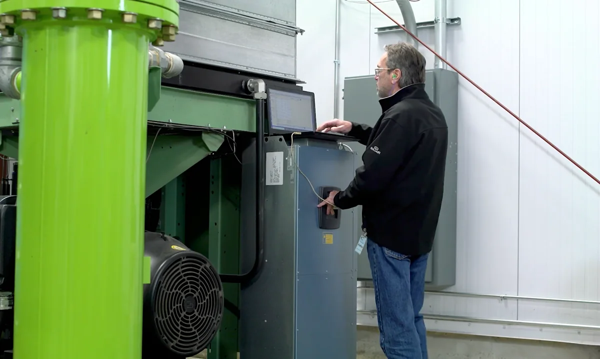 Brabazon technician running laptop diagnostics on a Sullair compressed air system