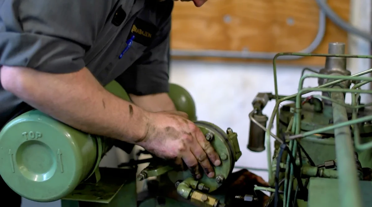 Brabazon technician repairing a reciprocating air compressor pump