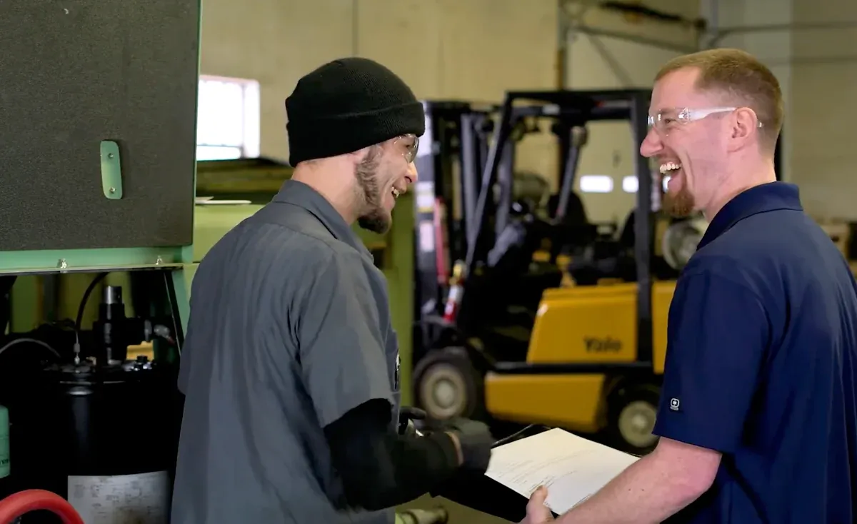 Brabazon team members sharing a laugh in the service shop