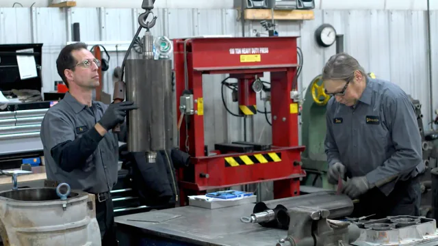 Technicians rebuilding a compressor air end in a repair shop