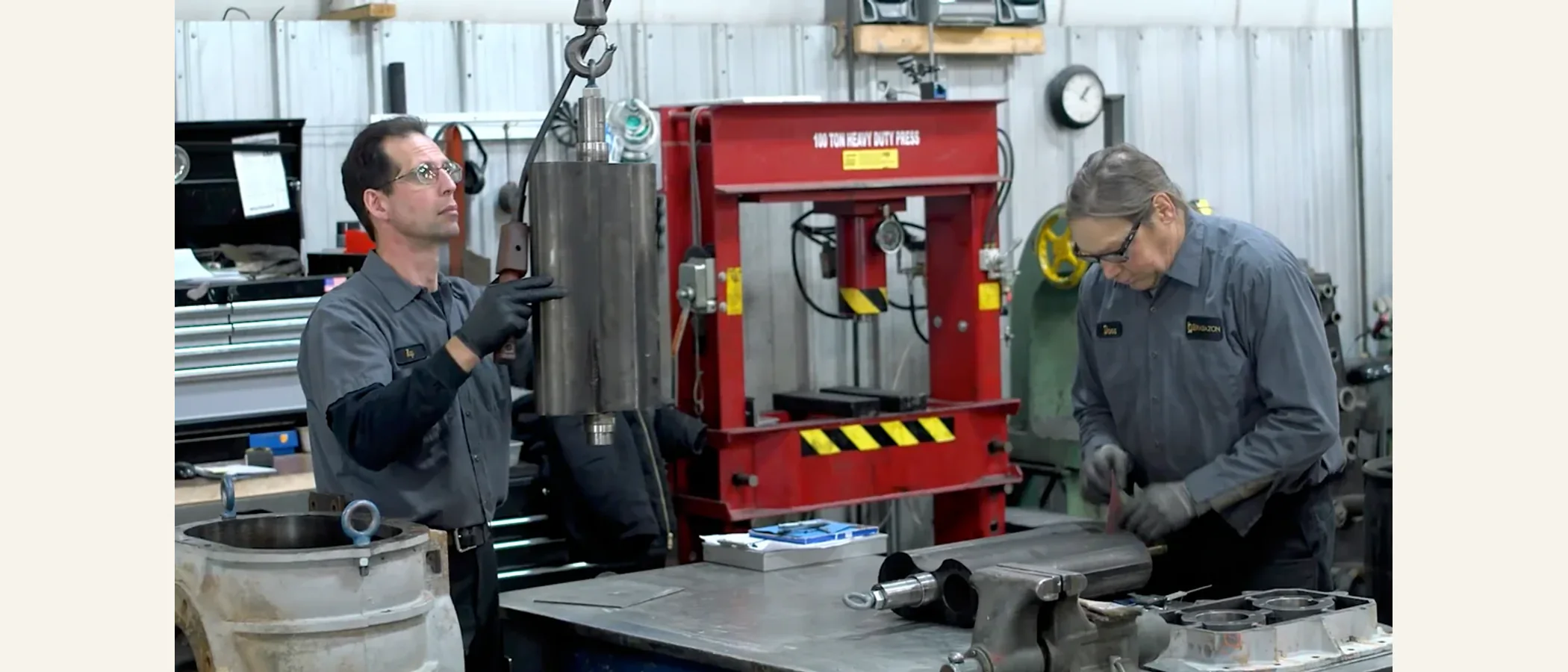 Technicians rebuilding a compressor air end in a repair shop
