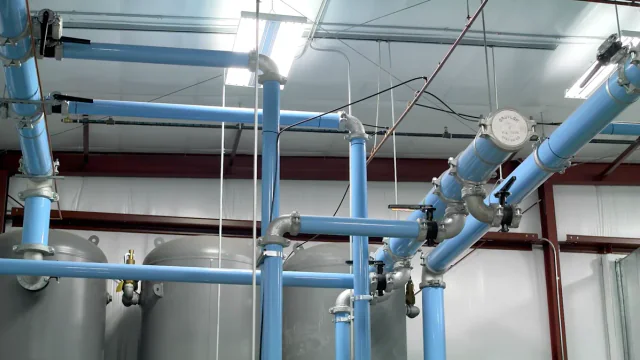 Overhead compressed-air piping installed across an industrial plant