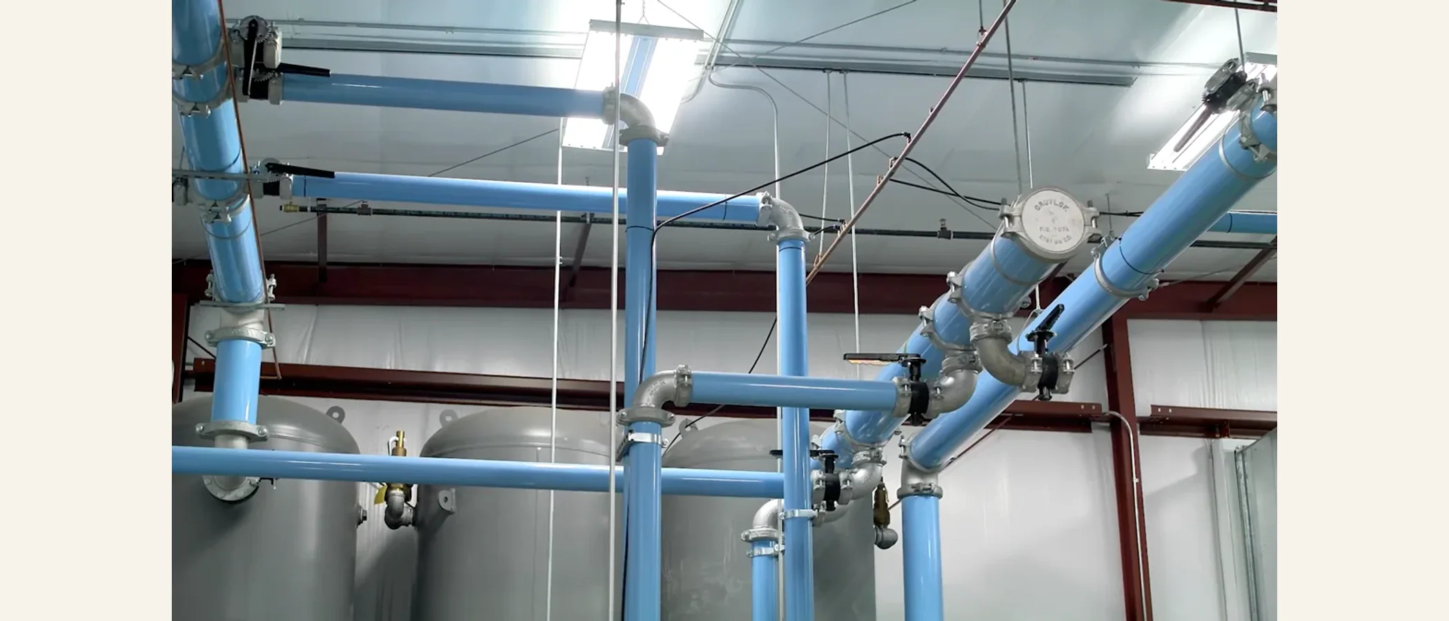 Overhead compressed-air piping installed across an industrial plant