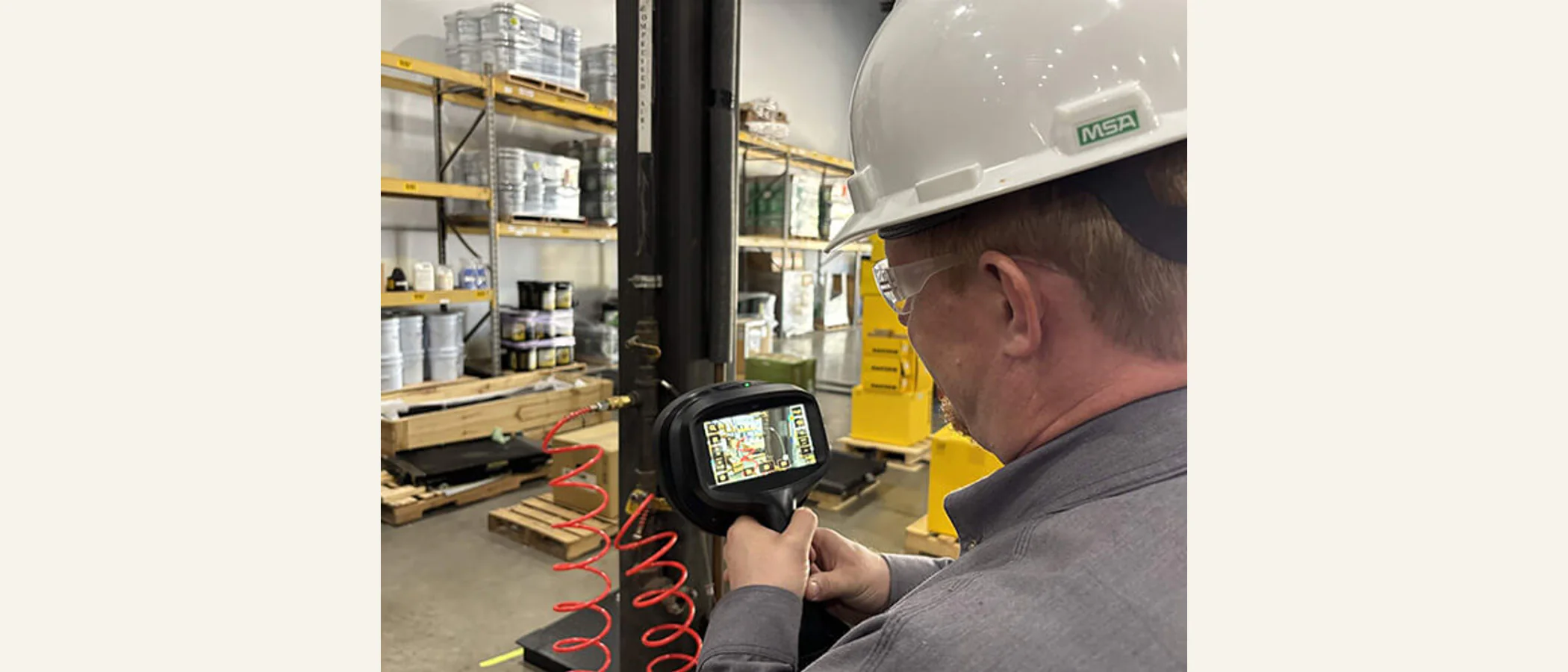 Technician using an instrument to inspect an industrial compressed-air system