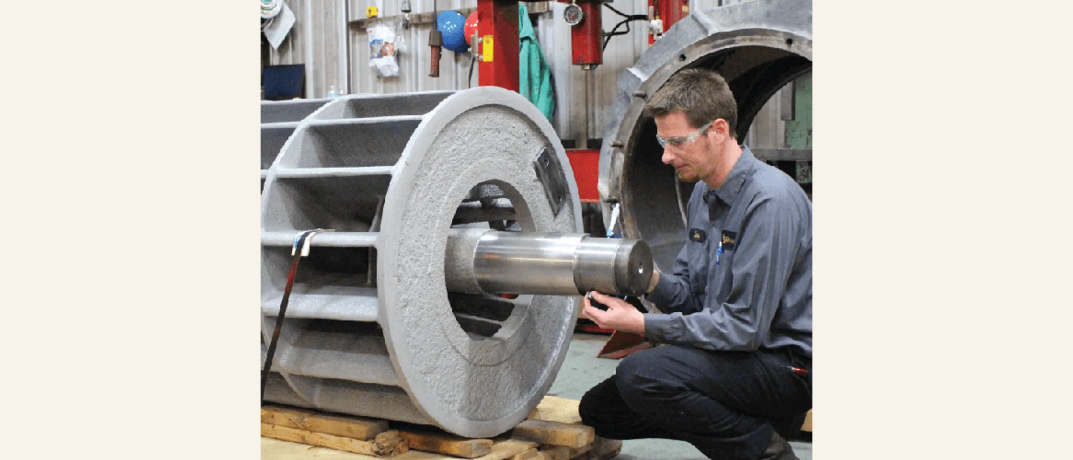 Technician servicing an industrial pump rotor in a repair shop