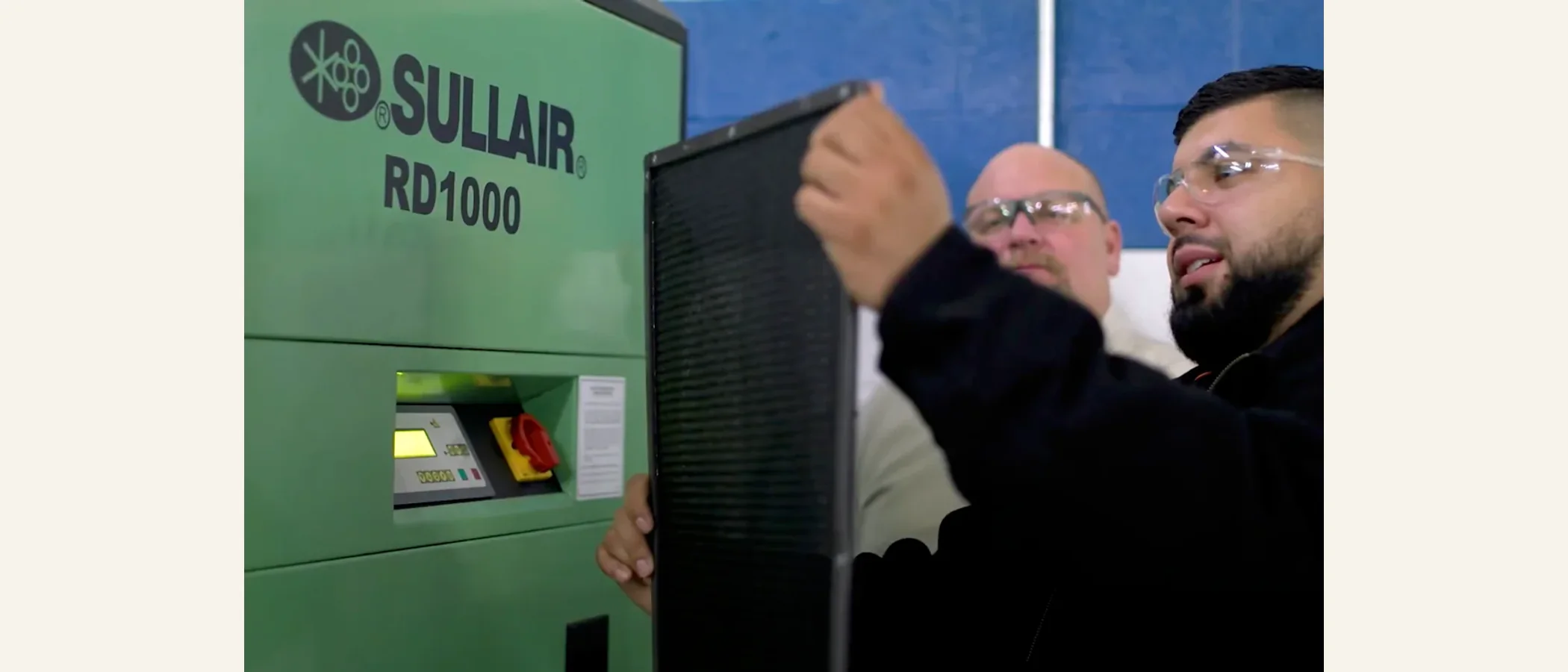 Technician inspecting a Sullair RD1000 dryer and filter
