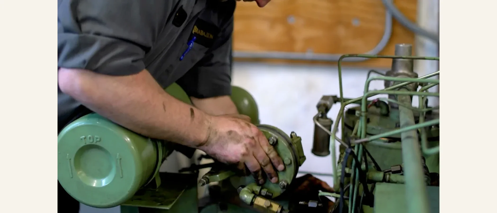Technician repairing the mechanism of a reciprocating compressor