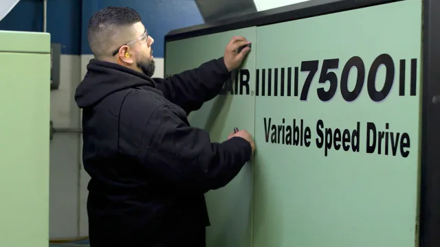 Technician servicing a Sullair 7500 VSD compressor