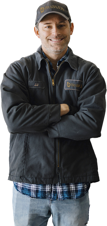 Brabazon owner standing with arms crossed in a Brabazon cap and dark jacket