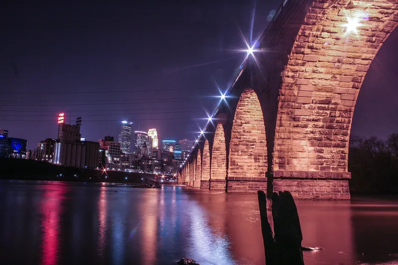 Stone Arch Bridge and Minneapolis skyline at night